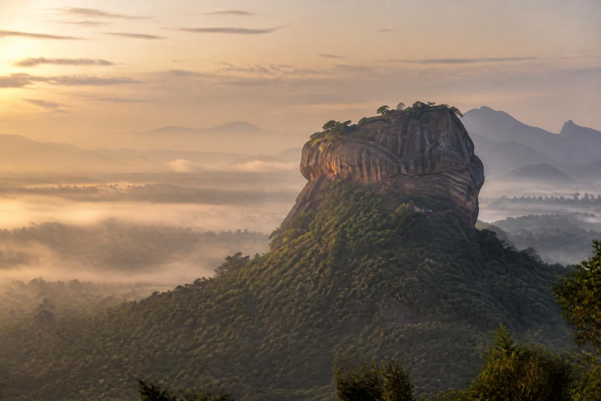 Sigiriya rock rising through morning mist in central Sri Lanka